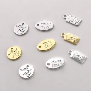 Macro detail of 14k gold and silver plated DIY jewelry charms with engravings