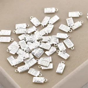 Close-up detail of silver rectangular queen profile charms for DIY jewelry accessories