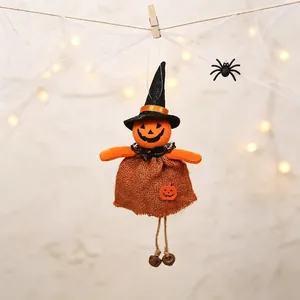Detailed macro view of a Halloween burlap pumpkin elf doll hanging with a witch hat and bells