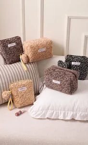 Various Maillard style leopard print plush makeup bags with soft texture and tassels