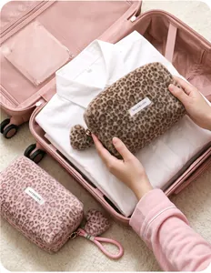 Plush leopard print makeup bag shown inside a suitcase for travel storage