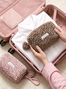 Large leopard print plush makeup bag with soft fur and heart charm stored in luggage