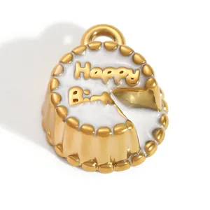 Close-up of gold-plated birthday cake pendant with white enamel and Happy Birthday text