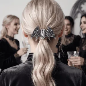 Detail shot of a sparkling rhinestone bat hair clip for Halloween on a blonde ponytail