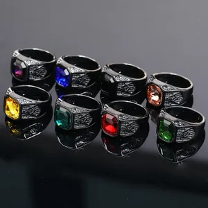 Detail view of hip-hop style black titanium steel rings with assorted colored gemstones.