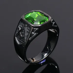 Close-up detail of men's black Freemason ring with a large green emerald-cut stone.