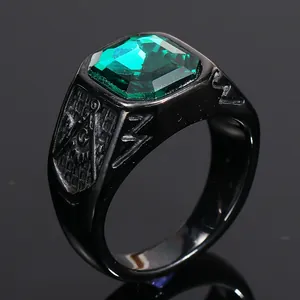 Close-up of men's black ring with green gemstone and engraved Freemasonry square and compass