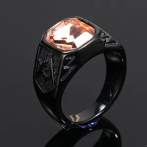 Close-up of a black titanium steel ring with an orange gemstone and Masonic symbol.