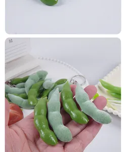 Macro detail of realistic PVC edamame models showing fuzzy and smooth textures in hand