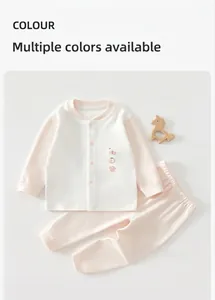 Two-piece baby cotton loungewear set featuring soft pink pants and a white long-sleeve top