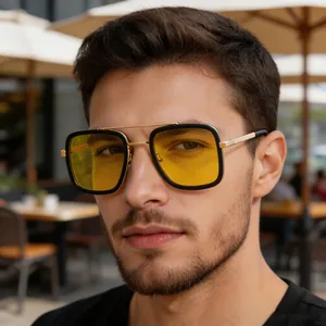 Close-up detail of fashionable square sunglasses featuring yellow lenses and gold metal frame
