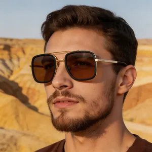 Close-up of a male model wearing fashionable square metal frame sunglasses in desert