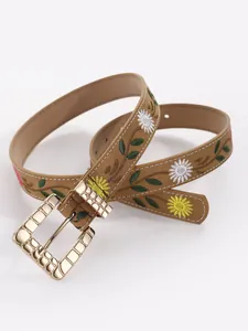 Detailed view of women's bohemian brown belt with floral embroidery and gold buckle