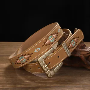Close-up detail of a vintage bohemian embroidered leather belt with geometric diamond patterns