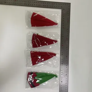 Detail view of mini Christmas hat cutlery holders with ruler for size reference