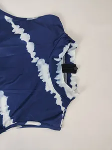 Close-up of blue tie-dye sleeveless jumpsuit featuring a high neck and back zipper.