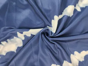 Detailed view of blue and white tie-dye fabric texture for slim fit summer jumpsuit