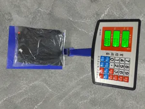 Weight measurement detail of black women's casual jumpsuit on electronic scale