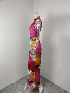 Side profile view of a vibrant sleeveless floral print jumpsuit on a transparent mannequin