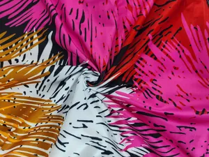 Detailed macro view of vibrant tropical leaf pattern fabric for women's summer jumpsuit