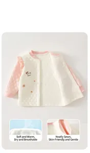 Detail shot of thermal baby top showing soft quilted fabric and snap button closure