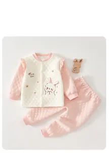 Close-up of pink and white quilted baby thermal underwear set with cute rabbit design