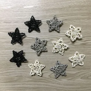 Detailed view showing a variety of 9cm hand-woven rattan stars in black, grey and white.