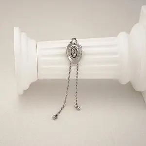 Detailed macro view of a silver western cowboy hat pendant necklace on a classical white column
