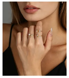 Close-up detail view of elegant gold celestial rings featuring moon and star zircon accents