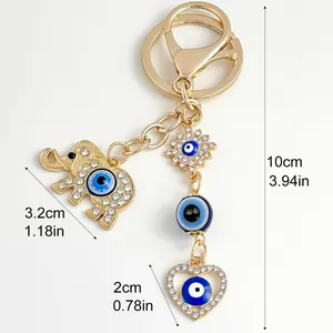 Detailed view of evil eye elephant keychain with heart and sun charms and dimensions