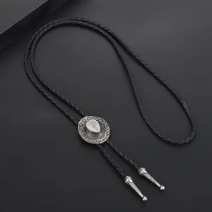 Detailed shot of Western bolo tie featuring a silver cowboy hat slide and black cord.