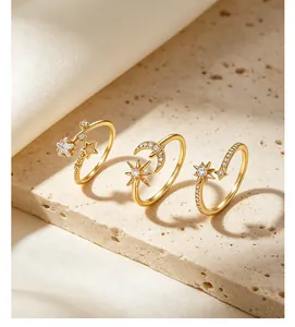 Close-up detail of three gold S925 silver rings with moon and star zirconia designs