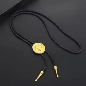 Macro detail of a classic western bolo tie featuring a polished gold-tone cowboy hat charm