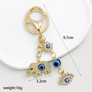 Gold elephant keychain with blue evil eye charms, 9.7cm total length and 16g weight