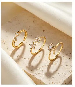 Detailed view of three gold s925 sterling silver rings with elegant zircon inlays