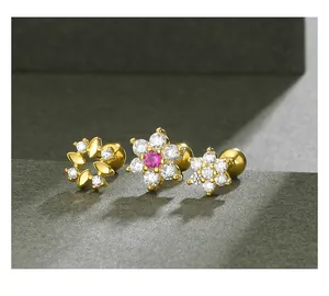 Detailed macro view of s925 silver gold-plated flower stud earrings with CZ crystals.