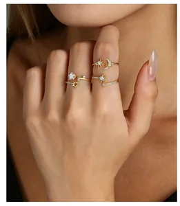 Detailed view of elegant golden celestial rings with moon and star zircon accents