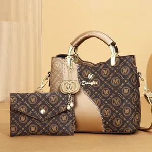 Macro detail of fashionable monogram printed tote bag and matching pouch set in brown.