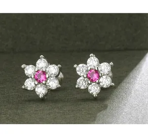 Macro view of flower stud earrings with pink center stone and sparkling petals