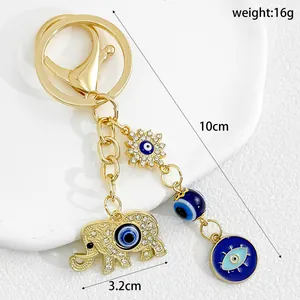 Detailed macro view of golden elephant evil eye keychain with 10cm length and 16g weight