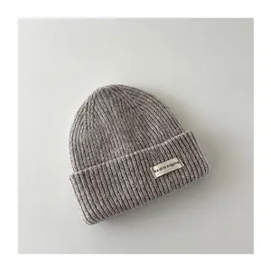 Close-up of the soft gray ribbed knit texture and label on this warm winter baby beanie