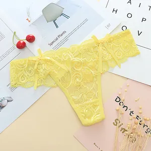 Detailed view of yellow floral lace thong featuring delicate side bows and see-through mesh