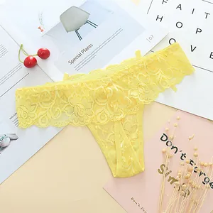 Detail shot of yellow floral lace thong with scalloped edges and transparent texture