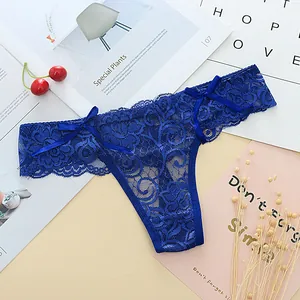 Detailed close-up showing the intricate floral lace and bow accents of the blue thong