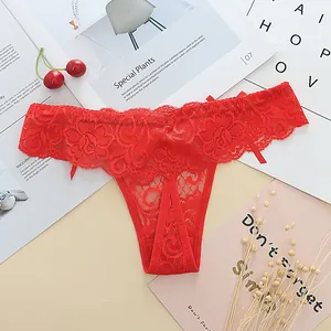 Detailed close-up of red floral lace thong featuring an elegant low waist design