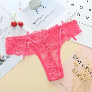 Close-up detail of sexy rose red lace thong with delicate bow accents