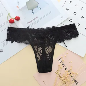 Close-up macro view showing intricate black floral lace texture on sexy low-rise T-back thong