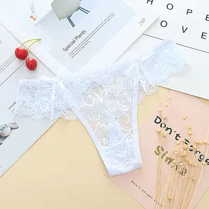 Detailed view of white lace jacquard thong with decorative bows on the waist.