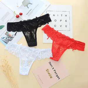 Detailed view of three sexy lace jacquard thongs in black, red, and white with bows
