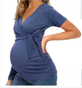 Detail side view of a blue V-neck wrap maternity breastfeeding t-shirt with side tie.